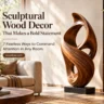 A horizontal graphic titled "Sculptural Wood Decor That Makes a Bold Statement: 7 Fearless Ways to Command Attention in Any Room". The image features a large, flowing, abstract wooden loop sculpture displayed on a black plinth inside a sunlit living room. Warm natural light filters in across a beige sofa, round coffee table, and wooden bookshelf. A button highlights the website woodzaa.com.